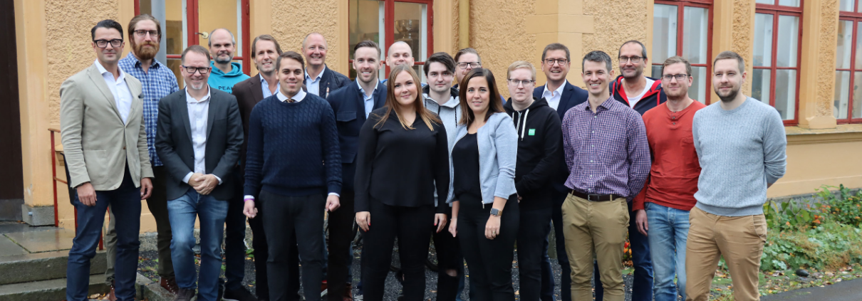 Team of experts from COS Systems showcasing Fiber Network Software outside headquarters.