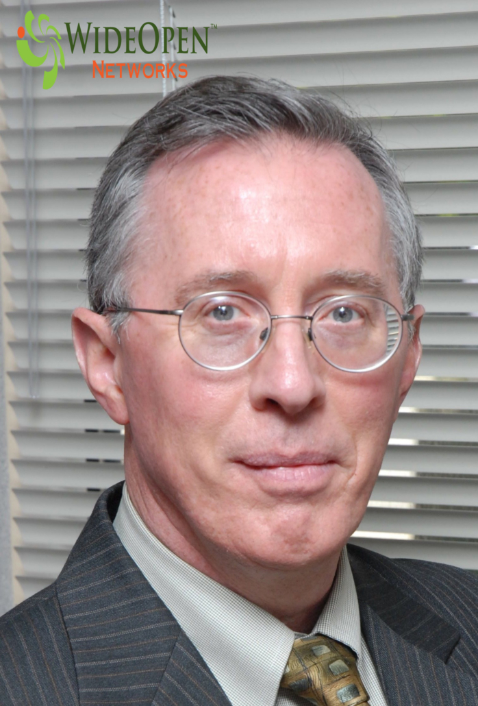 CEO of WideOpen Networks, an expert in fiber network management, standing confidently in an office setting