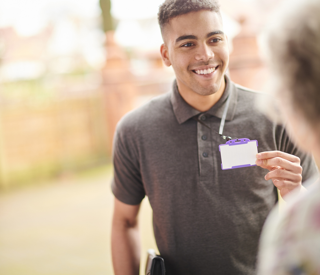 Young sales representative showing his ID card to a potential fiber customer at their door