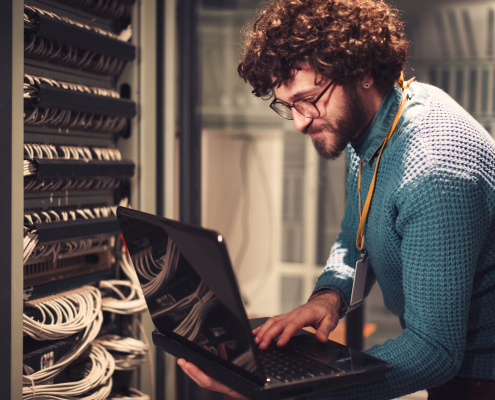 Fiber technician working at a network rack